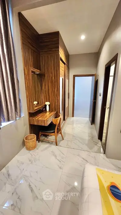 Modern bedroom with elegant wood accents and marble flooring