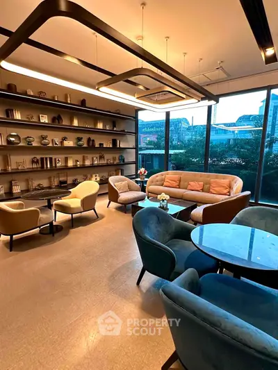 Luxurious modern living room with elegant seating and large windows offering a stunning view.
