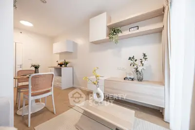 Modern living room with stylish decor and dining area in open layout apartment.