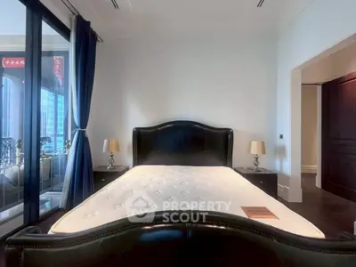 Luxurious bedroom with elegant black leather bed and city view balcony, perfect for urban living.