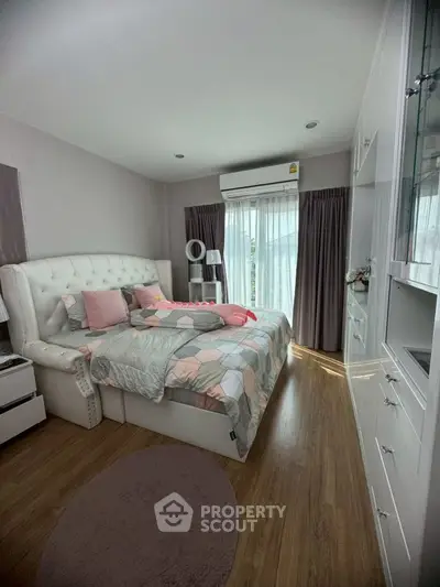 Charming bedroom with elegant decor and natural light, featuring a cozy bed and stylish furnishings.