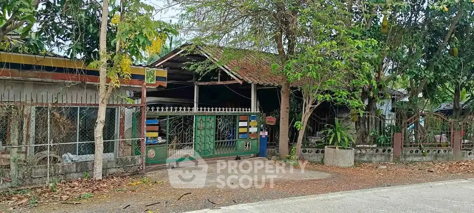 Charming rustic property with gated entrance and lush greenery, perfect for nature lovers seeking tranquility.