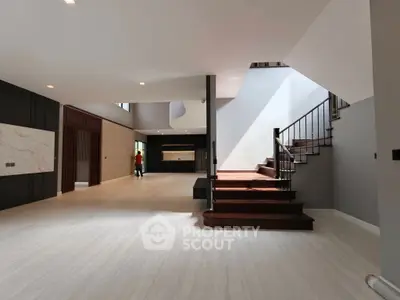 Spacious modern living room with elegant staircase and open layout