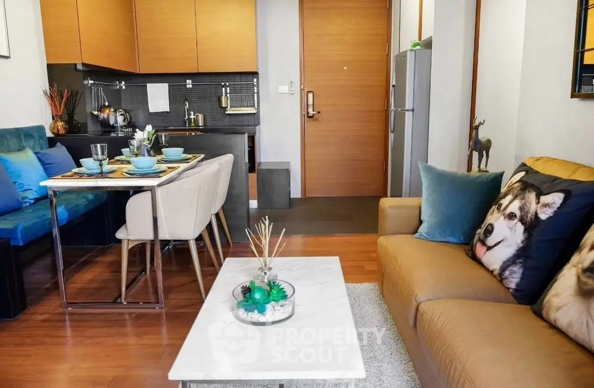 Modern living room with stylish decor and open kitchen layout, featuring cozy seating and elegant dining area.