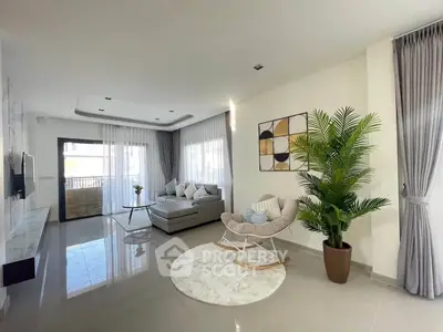 Spacious modern living room with elegant decor and large windows for natural light.