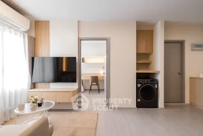 Modern living room with sleek TV setup and adjacent study area