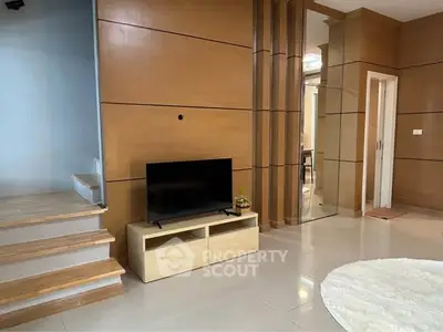 Modern living room with sleek wooden paneling and minimalist TV setup