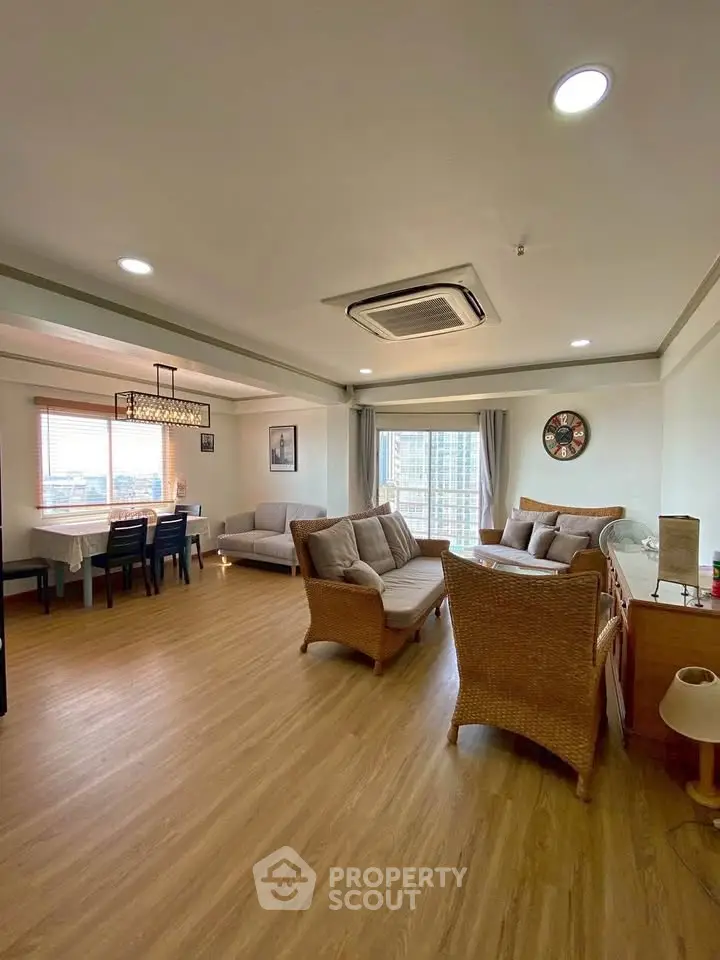 Spacious living room with elegant furniture and large windows offering natural light.