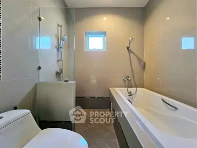 Modern bathroom with sleek design and bathtub in contemporary home.