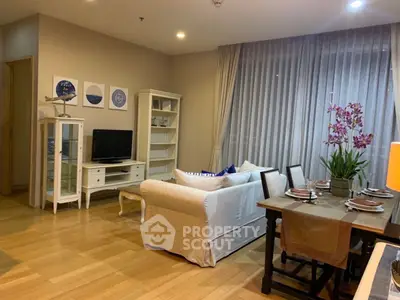 Charming living room with cozy seating and elegant dining area, perfect for relaxation and entertaining.