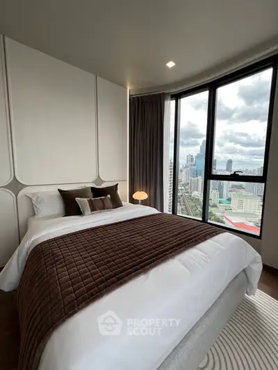 Luxurious bedroom with stunning city view from floor-to-ceiling windows, featuring elegant decor and cozy bedding.