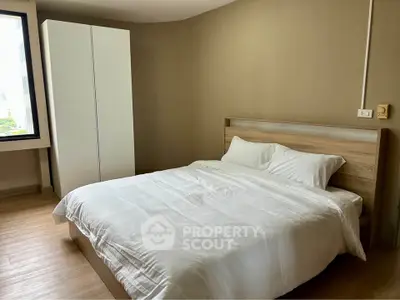 Spacious bedroom with modern design and natural light in a stylish apartment.