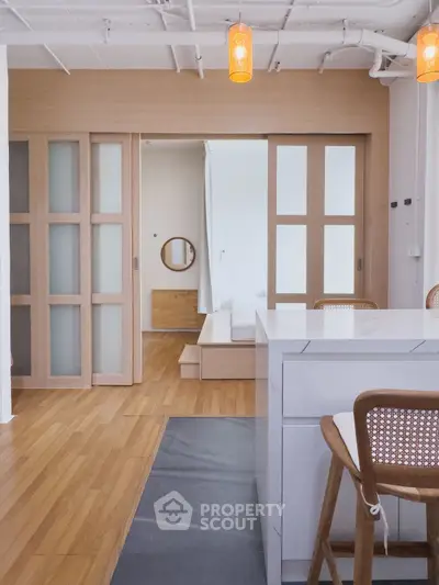 Modern open-plan living space with wooden sliding doors and stylish kitchen island.