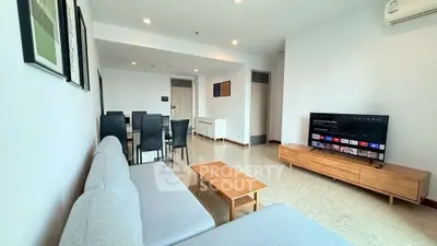 Spacious modern living room with sleek furniture and entertainment setup