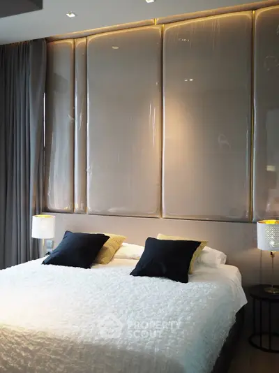 Luxurious modern bedroom with elegant lighting and plush bedding