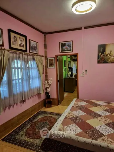 Charming bedroom with pink walls and cozy decor