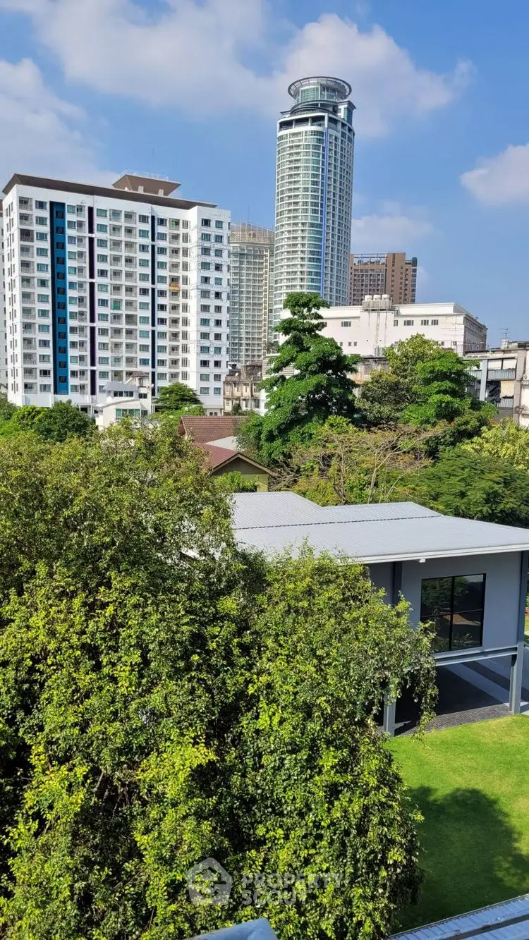 Stunning cityscape view with modern high-rise buildings and lush greenery, perfect for urban living.