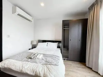 Modern bedroom with air conditioning and wardrobe in a stylish apartment.