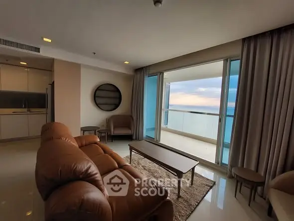 Luxurious living room with ocean view and modern furnishings in a high-rise apartment.