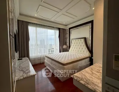 Luxurious bedroom with city view, elegant decor, and marble accents in high-rise apartment.