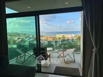 Stunning balcony view with ocean and cityscape, perfect for relaxation and enjoying sunsets.