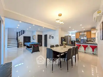 Spacious open-plan living and dining area with modern kitchen and stylish decor.