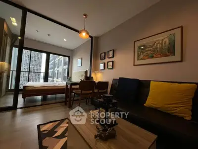 Modern living room with cozy decor and large windows in a stylish apartment.