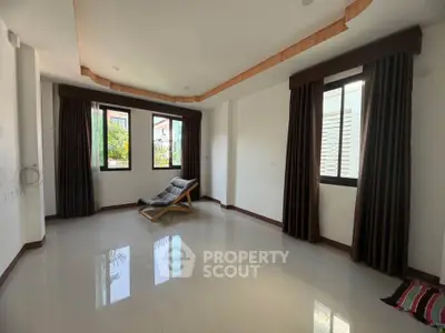 Spacious living room with large windows and modern decor