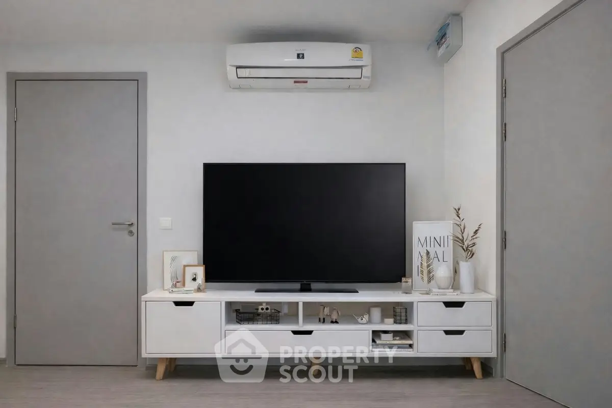 Modern minimalist living room with sleek TV unit and air conditioning