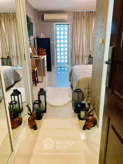 Chic bedroom with mirrored closet, cozy decor, and natural light for a serene living experience.