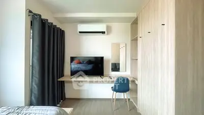 Modern bedroom with TV, air conditioning, and stylish furniture