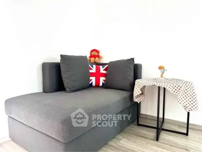 Modern living room with stylish gray sofa and decorative table, perfect for cozy relaxation.