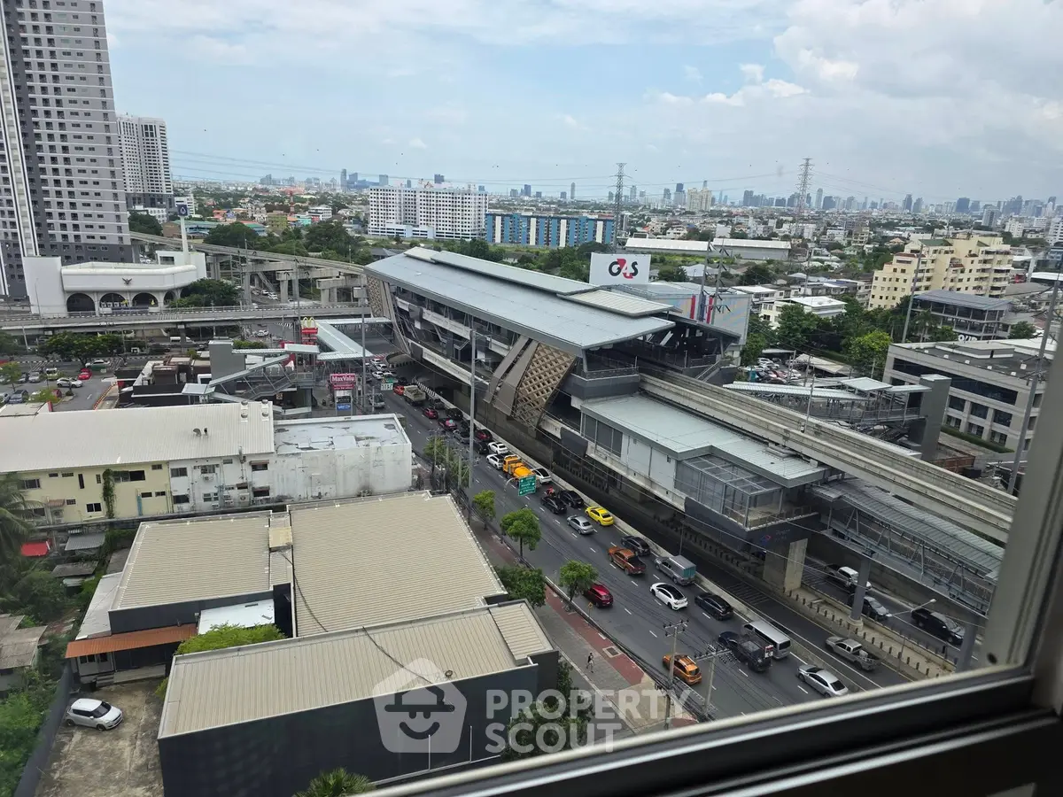 Stunning cityscape view from high-rise window overlooking urban transit and skyline.