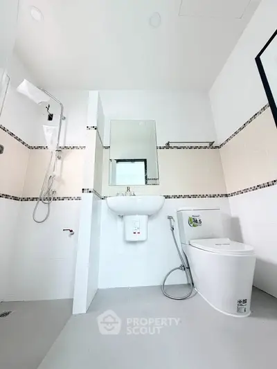 Modern bathroom with sleek fixtures and minimalist design, featuring a shower and toilet in a bright, clean space.