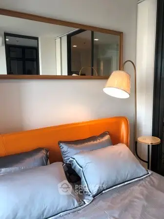 Modern bedroom with stylish orange headboard and elegant floor lamp
