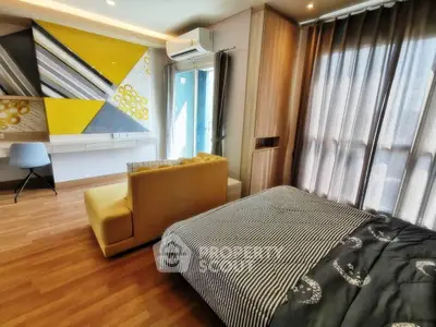 Modern bedroom with stylish decor and natural light, featuring a cozy bed and contemporary furniture.