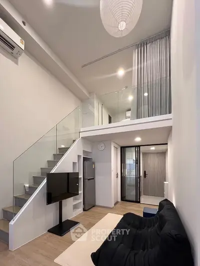 Modern loft apartment with mezzanine, sleek design, and open living space.