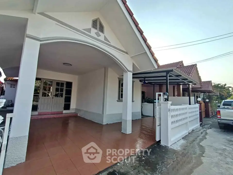 Charming single-story home with spacious carport and tiled entrance in a serene neighborhood.