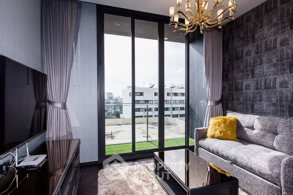 Luxurious living room with floor-to-ceiling windows and elegant chandelier