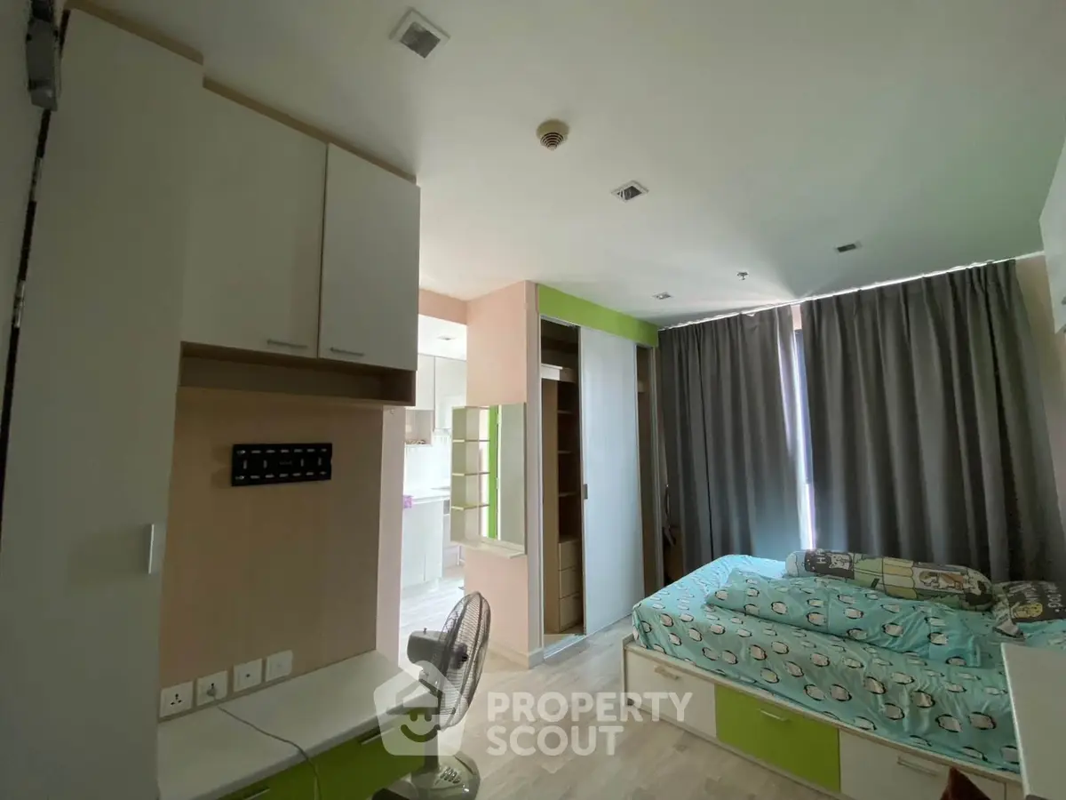 Cozy bedroom with modern furniture and natural light in a stylish apartment.
