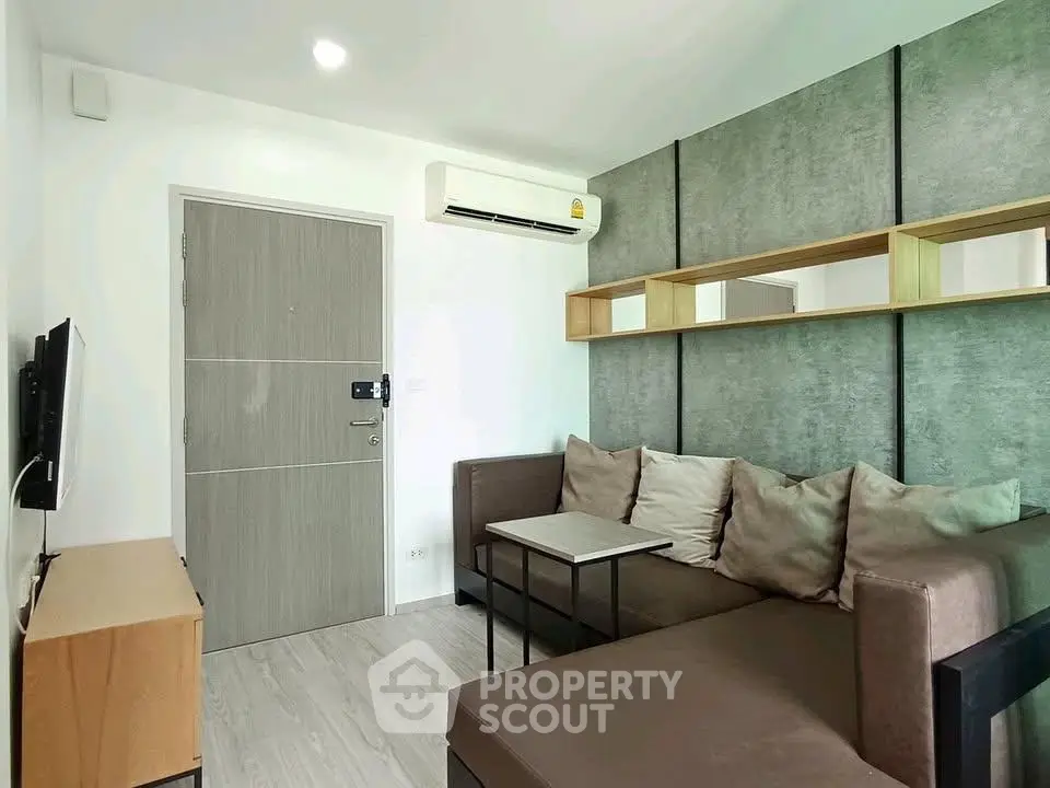 Modern living room with sleek design, featuring a comfortable sofa and wall-mounted TV.