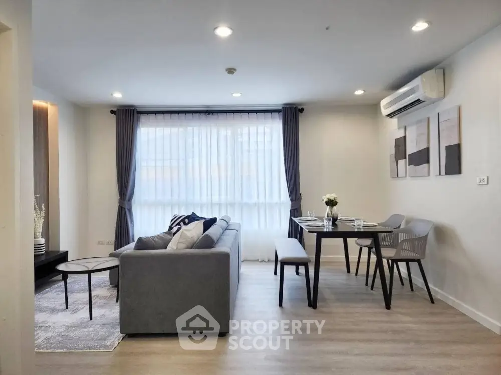 Modern living room with stylish decor and dining area in open layout apartment