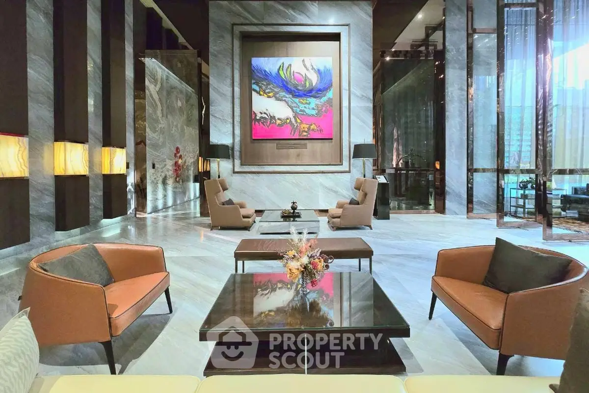 Luxurious modern lobby with elegant seating and vibrant artwork, perfect for upscale living.