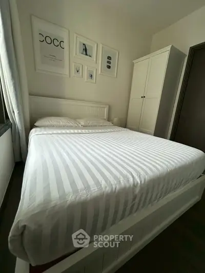 Cozy bedroom with stylish decor and ample natural light