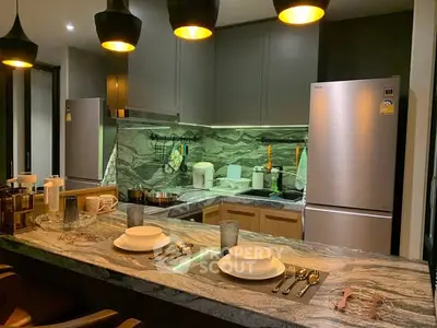 Modern kitchen with sleek appliances and elegant marble countertops, perfect for culinary enthusiasts.