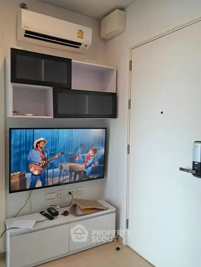 Modern living room with wall-mounted TV and air conditioning unit