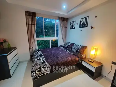 Elegant bedroom with large window and stylish decor in modern home.