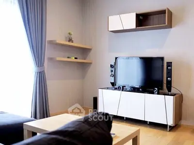 Modern living room with sleek TV setup and stylish shelving, perfect for cozy relaxation.