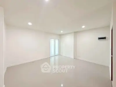Spacious empty room with glossy floors and bright lighting, perfect for customization.