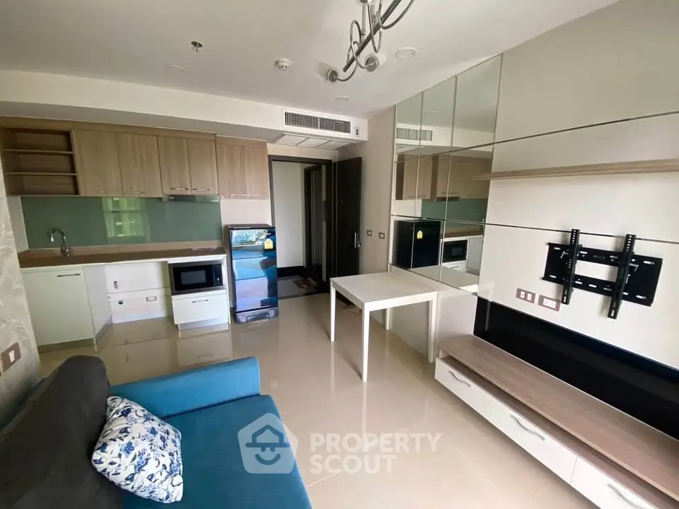 Modern open-layout living room with sleek kitchen and stylish furniture in a contemporary apartment.